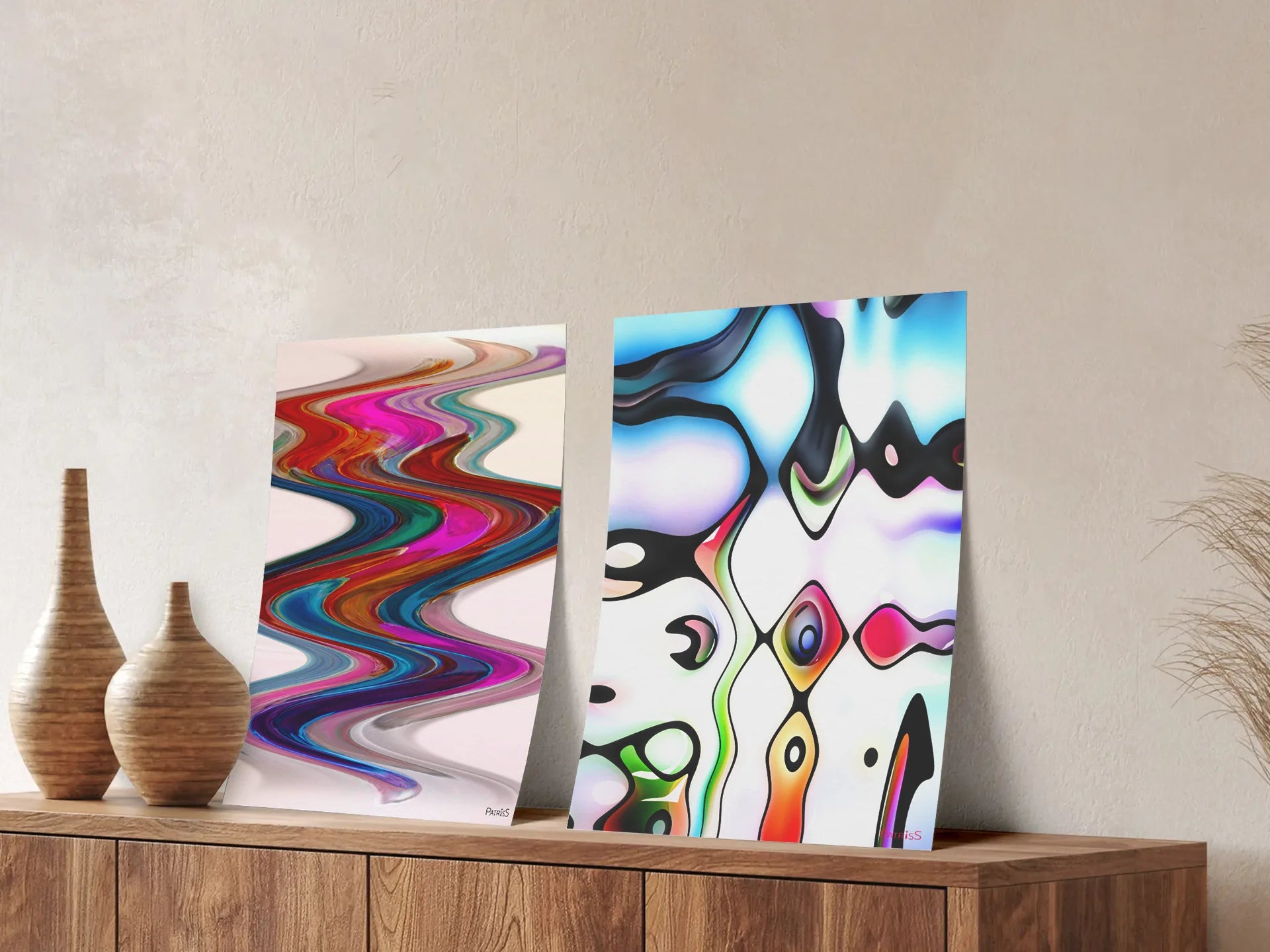 New Wave and Q-Bist, Posters by PatrisS, leaning against the wall, on a wooden cabinet with decorative wooden vases.