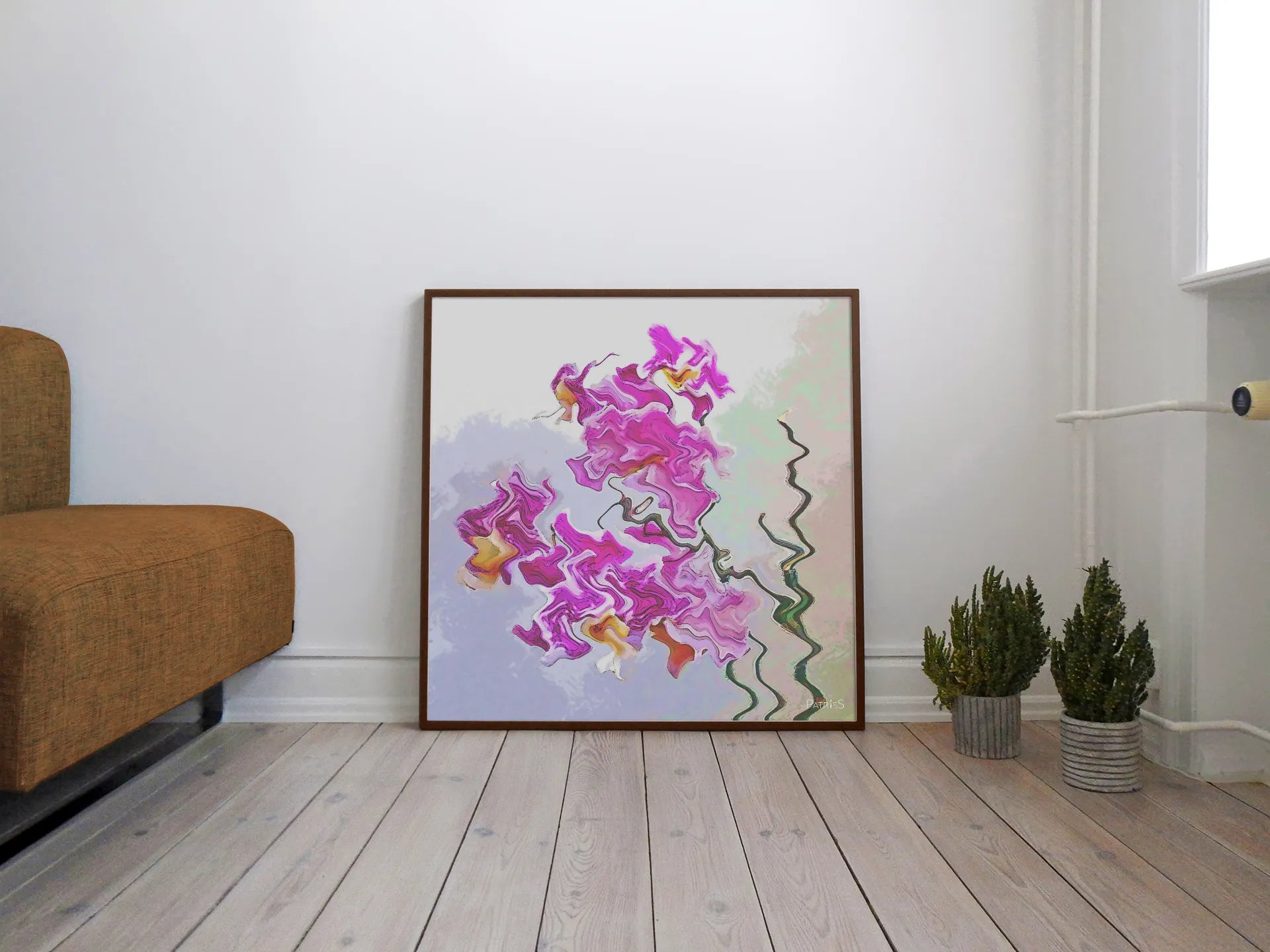 Orchidée, Wooden Framed Poster by PatrisS, leaning against the wall on the wooden floor, between a brown sofa and 2 plants.